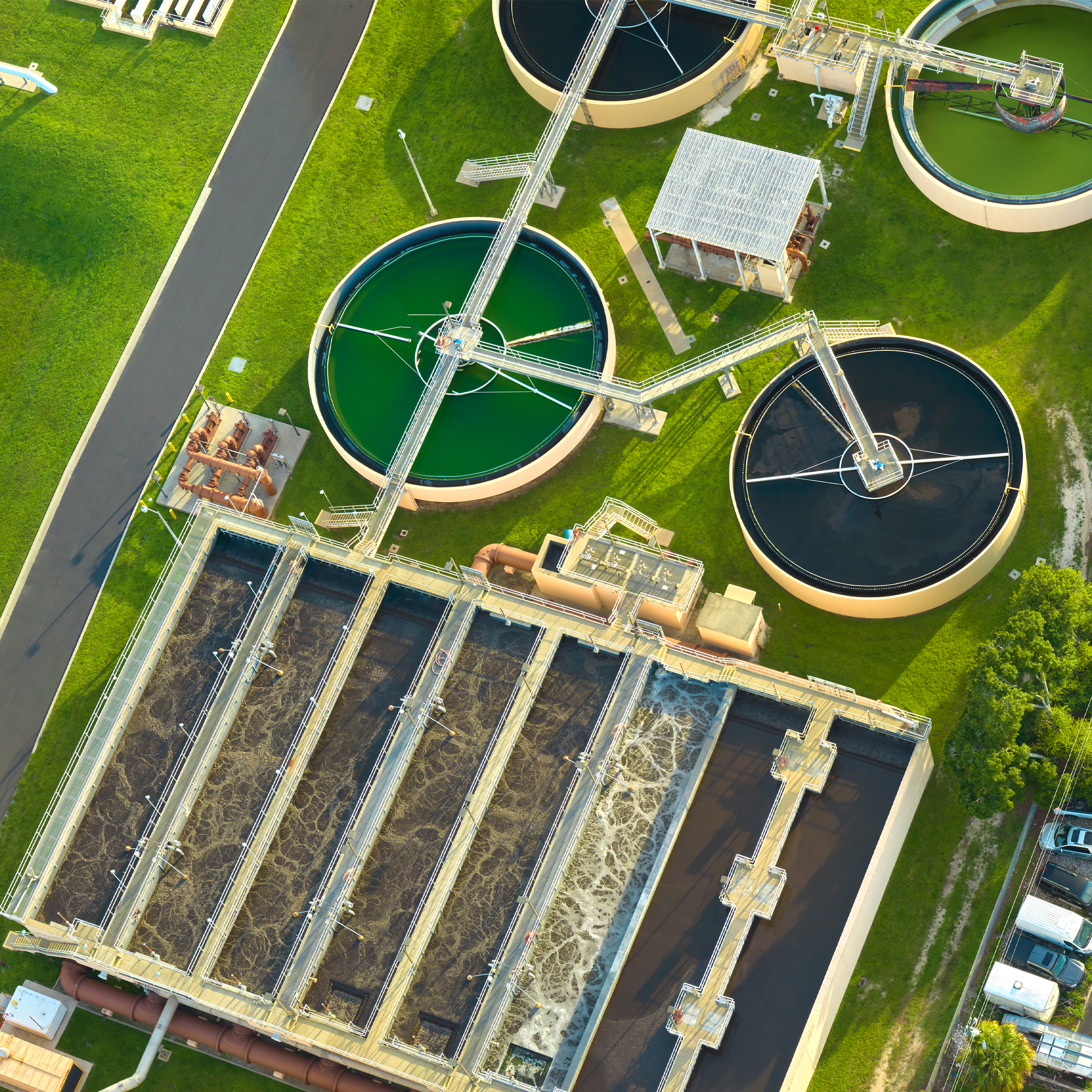 Aerial view of a sewage treatment plant with modern automation systems for efficient water treatment and compliance monitoring.